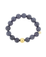 Lustora Bianca Stretch Bracelet with Midnight Blue Jade stones and gold bead accent on a white background