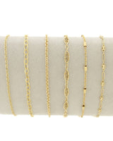 Set of Linked by Lustora™ gold chains for permanent jewelry on a white background