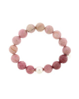 Pink Lustora Bianca Stretch Bracelet with Rhondite Haitian Flower stones and silver bead accent on a white background