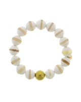 Lustora Bianca Stretch Bracelet with Tibetan stones and gold bead accent on a white background