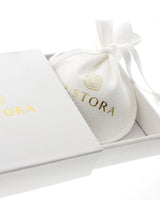 White Lustora jewelry pouch and open gift box with gold metallic lettering