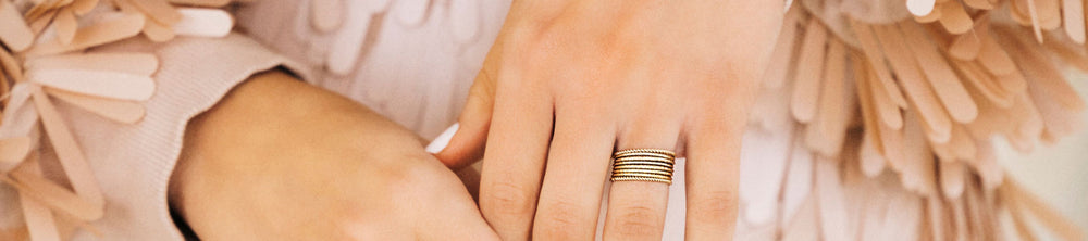 Close up image of a hand wearing a gold ring