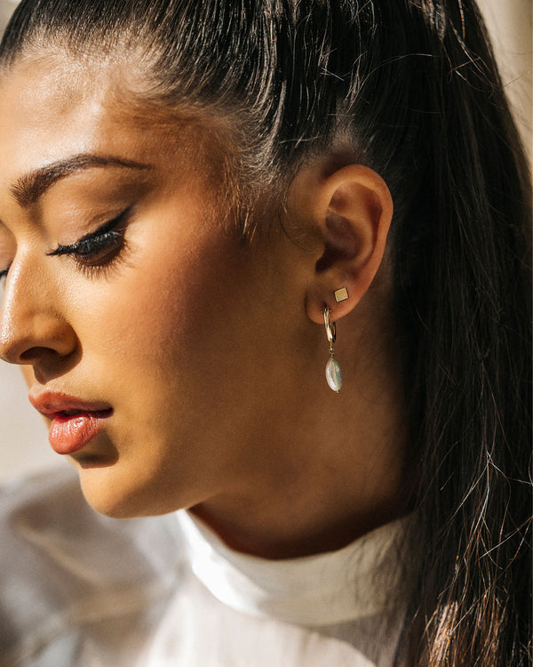 Maya wearing Mini Square Stud earrings in 14k gold-filled finish